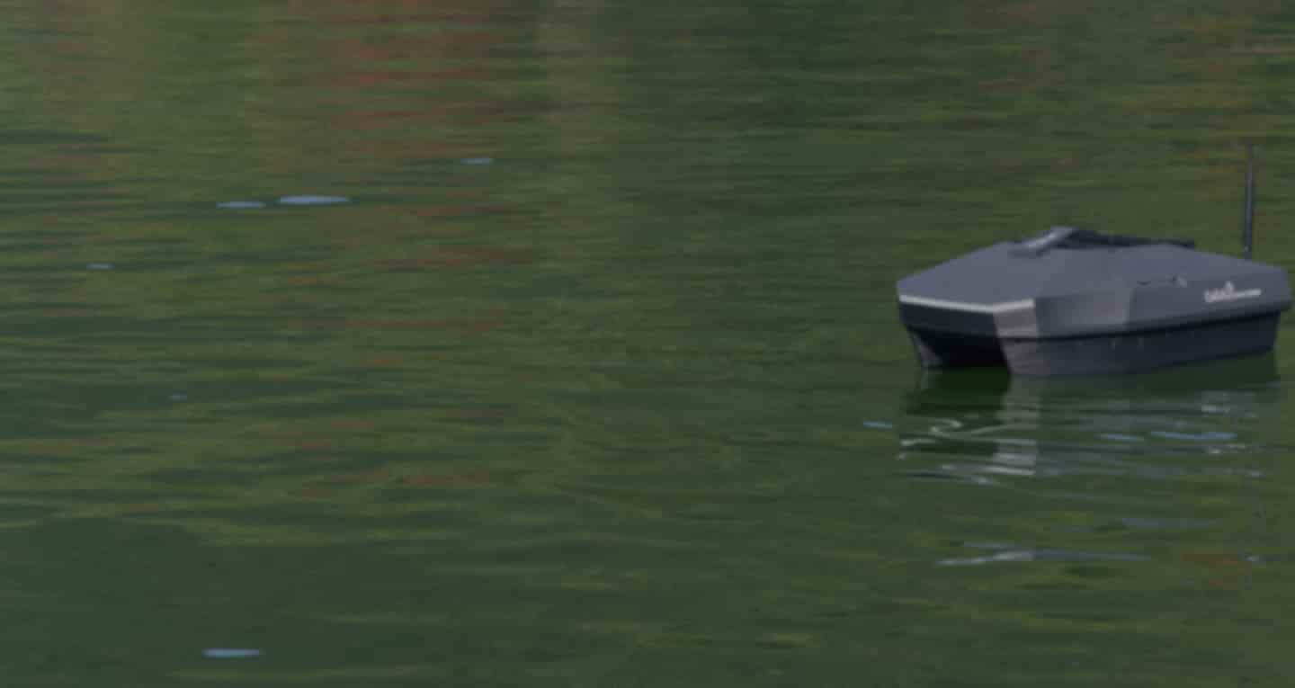 Rippton CatchX Black Samurai fishing bait boat with GPS, designed for carp fishing, featuring dual hoppers and sleek design