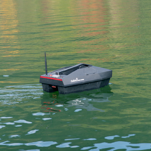 Remote control GPS bait boat with carbon-fiber floating on water, featuring sonar and fish finder for precision carp fishing